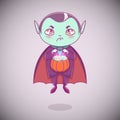 Halloween little vampire Dracula. Boy kid with angry face in halloween costume with pumpkin in his hands.