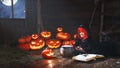 Halloween. little witch child cooking potion with pumpkin and Royalty Free Stock Photo