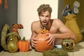 Halloween macho with open mouth, pumpkins and striped stockings