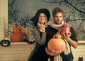 Halloween macho in scarf holding pumpkins