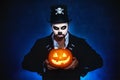 Halloween. magic skeleton with pumpkin. man in makeup and cost Royalty Free Stock Photo