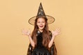 Halloween magic. Wizardry tradition. Overjoyed sorcerer. October fantasy. Cheerful female child in Halloween costume and witch hat