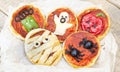 Halloween mini pizza funny food for children background old wood