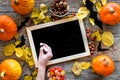 Halloween mockup. Chalkboard near paper bats and pumpkins on wooden background top view