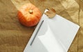 Halloween mockup with pumpkin and sheet with empty space and burlap background. Orange pumpkin and autumn leaves