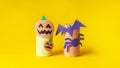 Halloween monster toy from toilet paper tube. Pumpkin jack, bat and spider on yellow or orange background. Easy DIY