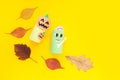 Halloween monster toy from toilet paper tube. Zombie and pumplin jack toys on yellow or orange background. Easy DIY