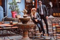 Young attractive couple with undead posing near mexican restaurant outdoors.