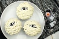 Halloween mummy cupcakes on white plate