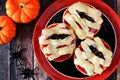 Halloween mummy mini pizzas on black and orange plate