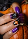 Halloween nail art with coat of purple enamel