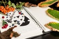 Halloween.Notepad for recording with painted black Jack. dry foliage dry berries with empty space