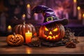 Halloween, orange pumpkin with carved face, candles and autumn leaves on wooden table with blurry background
