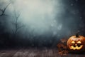 Halloween pumpkin with a scary smiling luminous face with copy space on a fog smoke dark background Royalty Free Stock Photo