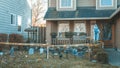 Halloween outdoor decorations. Front yard of private house decorated by fake skull, bones hands, tombstones and grates