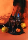 Halloween, a pair of glasses with red wine, pumpkins, burning candles, Halloween decorations Royalty Free Stock Photo