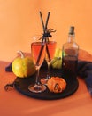 Halloween, a pair of glasses with red wine, pumpkins, burning candles, Halloween decorations