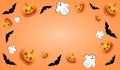 Halloween paraphernalia on an orange background, flat lay, with copy space in the center of the background. Along the