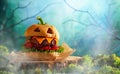 Halloween party burger in shape of scary pumpkin  on  wooden board. Halloween food concept Royalty Free Stock Photo