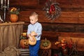 Halloween party with child holding painted pumpkin