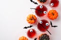 Halloween party concept. Top view photo of drink in glasses with floating eyes and spiders pumpkins bat silhouettes centipede and Royalty Free Stock Photo