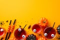 Halloween party concept. Top view photo of floating eyes punch in glasses cocktail straws pumpkins insects centipedes cockroach Royalty Free Stock Photo