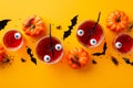 Halloween party concept. Top view photo of glasses with drink floating eyeball punch pumpkins bat silhouettes insects centipedes Royalty Free Stock Photo