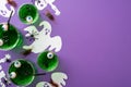 Halloween party concept. Top view photo of glasses with green floating eyes punch skeleton ghost silhouettes spiders centipede and