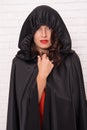 Halloween party. Damn pretty woman devil. Death in black cloak symbol. Vampire in cloak sexy devil girl. Woman tempting Royalty Free Stock Photo