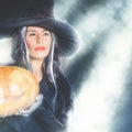 Halloween party 2016! Fashion asian woman like witch holding pumpkin Royalty Free Stock Photo