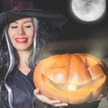 Halloween party 2016! Fashion asian woman like witch holding pumpkin Royalty Free Stock Photo