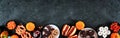 Halloween party food bottom border over a black stone banner background Royalty Free Stock Photo