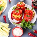 Halloween party food. Red stuffed peppers with scary cutout faces, witches brooms of cheese and other treats Royalty Free Stock Photo