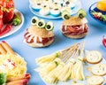 Halloween party food. Stuffed peppers with scary faces, cheese witches brooms, monster hamburgers, witch finger treats. Royalty Free Stock Photo