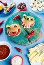 Halloween party food. Stuffed peppers with scary faces, cheese witches brooms, monster hamburgers, witch finger treats. Royalty Free Stock Photo