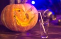 Halloween party. Funny Pumpkin with a cocktail. selective focus