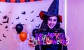Halloween party with a girl holding a Happy Halloween sign in hand