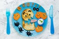 Halloween party ideas for kids - monster toast with pumpkin, olive spiders and white ghost sauce. Fun with food composition on th Royalty Free Stock Photo