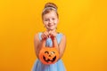 Halloween party. Little girl dressed as Cinderella on a yellow background. Royalty Free Stock Photo