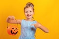 Halloween party. Little girl dressed as Cinderella on a yellow background. Royalty Free Stock Photo