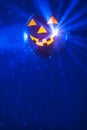 Halloween party pumpkin disco ball, blue shiny rays background