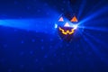 Halloween party pumpkin disco ball, blue shiny rays background