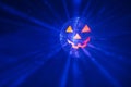 Halloween party pumpkin disco ball, jack o`lantern with shiny rays in smoke