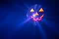 Halloween party pumpkin disco ball, jack o`lantern with shiny rays in smoke Royalty Free Stock Photo