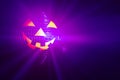 Halloween party pumpkin disco ball, jack o'lantern with shiny rays in smoke Royalty Free Stock Photo