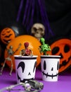 Halloween party. Skeletons coming out from the cup with balloons and skull in background Royalty Free Stock Photo