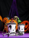 Halloween party. Skeletons coming out from the cup with balloons and skull in the background Royalty Free Stock Photo