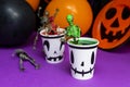 Halloween party. Skeletons coming out from the cup with balloons and skull in the background Royalty Free Stock Photo