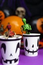 Halloween party. Skeletons coming out from the cup with balloons and skull in background Royalty Free Stock Photo