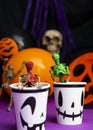 Halloween party. Skeletons coming out from the cup with balloons and skull in the background Royalty Free Stock Photo